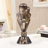 Trophée boxe constituté d'un gant de boxe sur une statue étoilée en bronze